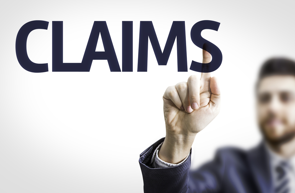 man pointing at a the word: Claims