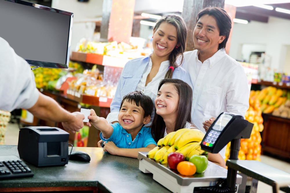 Family at a grocery store checkout lane